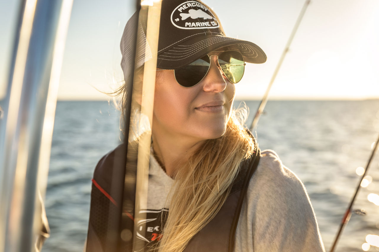 Woman in sunglasses wearing a Mercury Marine hat